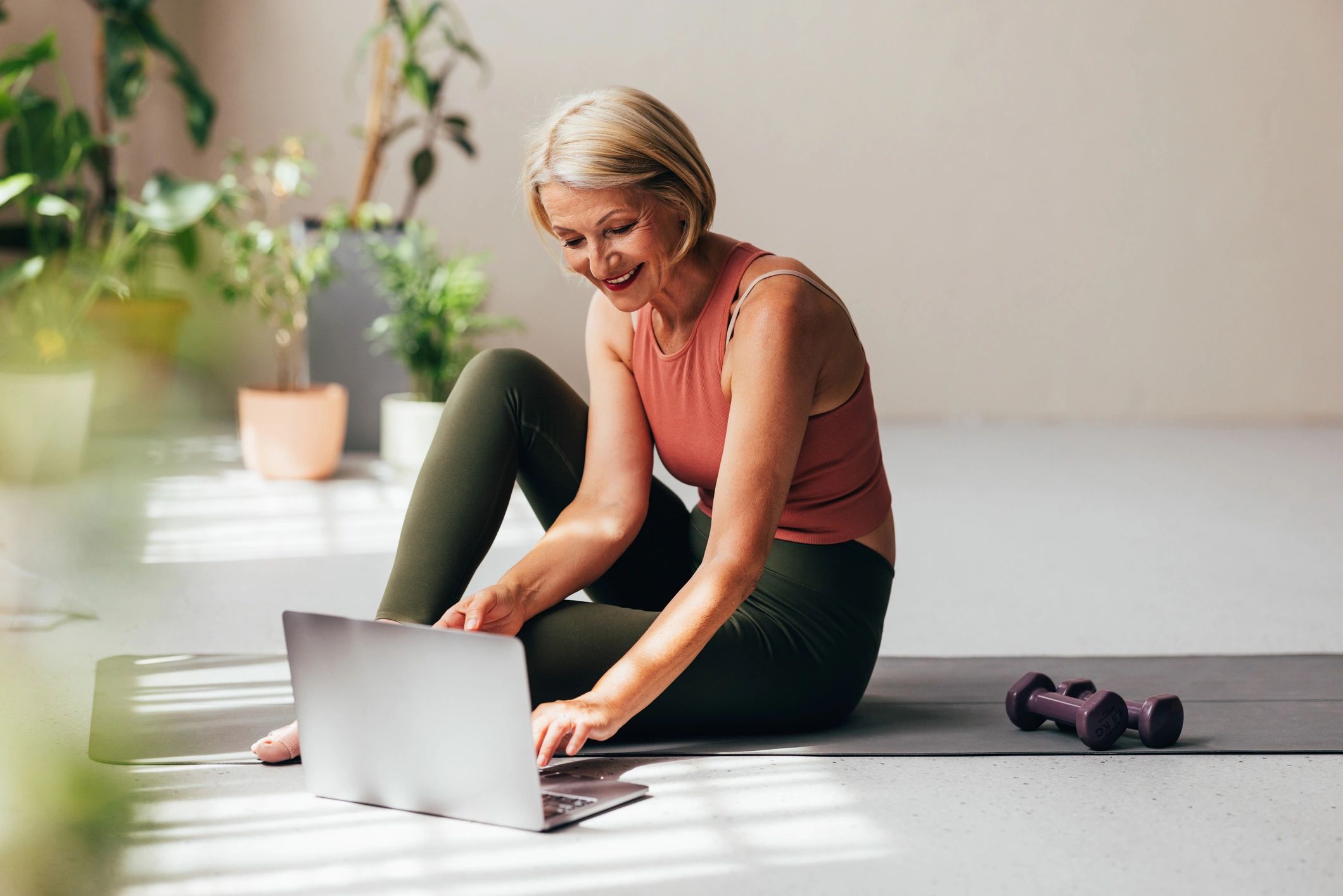 Woman using a laptop after a wellness workout