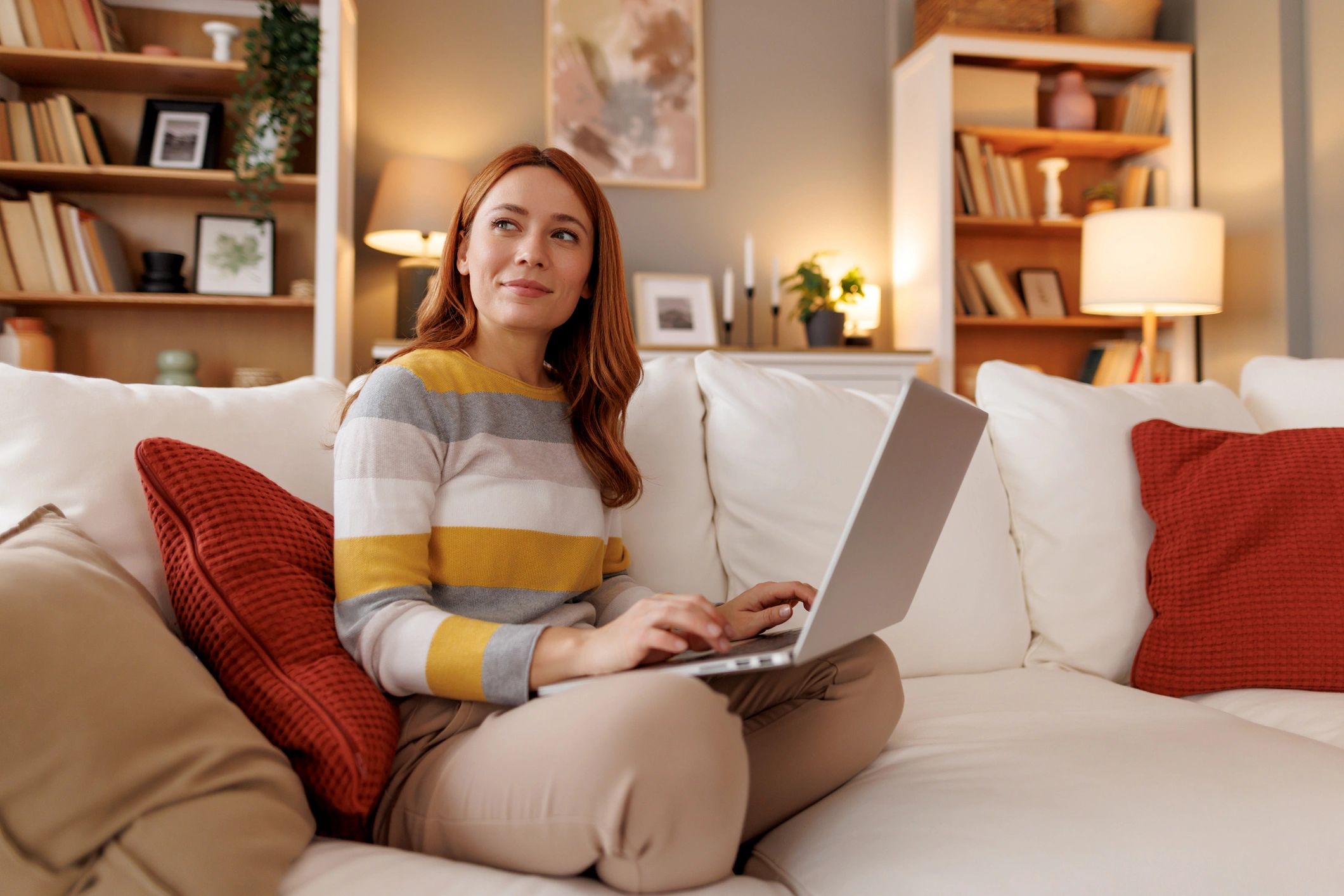 Woman using a laptop while planning personal growth goals at home
